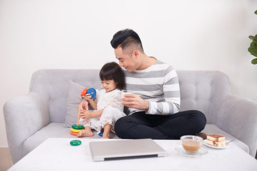 Father and daughter playing with bricks