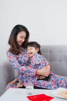 Vietnamese mother and daughter celebrate new year at home. Tet Holiday.