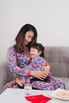 Vietnamese mother and daughter celebrate new year at home. Tet Holiday.