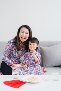 Vietnamese mother and daughter celebrate new year at home. Tet Holiday.