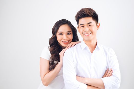 Happy together. Young in love couple smiling and standing against background