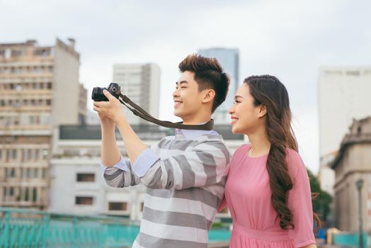 Young lovers walking around city on vacation, enjoying traveling together, outdoors.