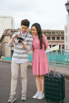 Young lovers walking around city on vacation, enjoying traveling together, outdoors.