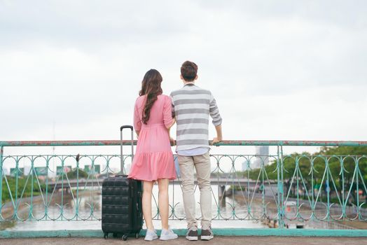 Young lovers walking around city on vacation, enjoying traveling together, outdoors.