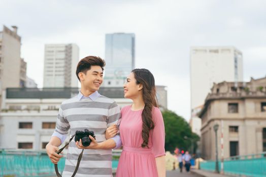 Young lovers walking around city on vacation, enjoying traveling together, outdoors.