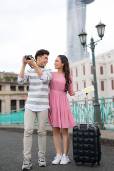 Photographers taking pictures of buildings in Saigon