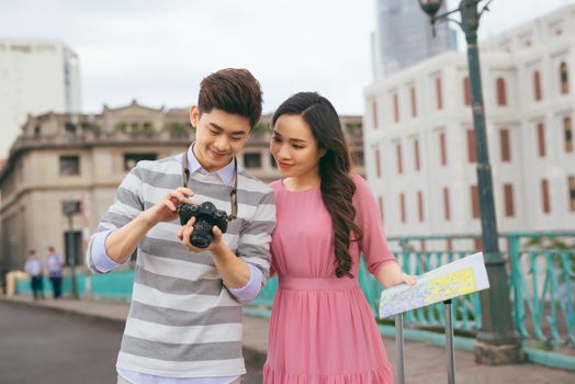 Young lovers walking around city on vacation, enjoying traveling together, outdoors.