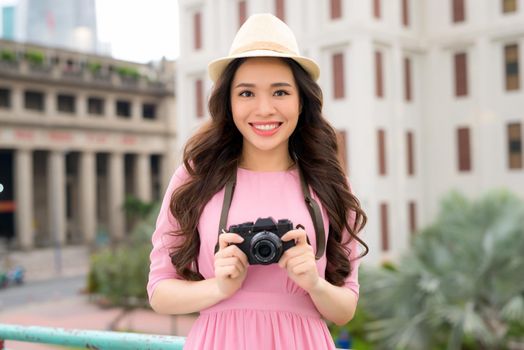 Portrait of Asian woman traveler photography hipster lifestyle on the road with camera