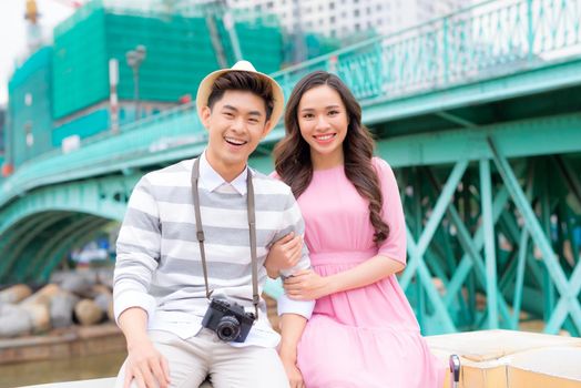 Young man and pretty girl are having fun in the city at evening.