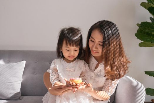 Happy young mother with daughter at home