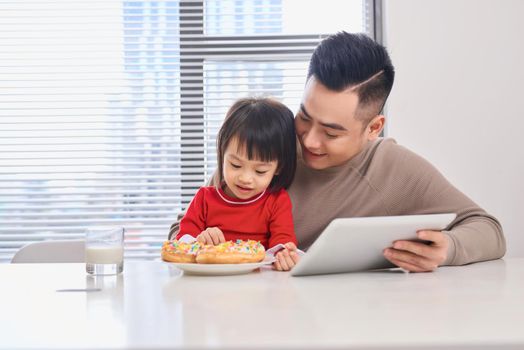 Man with daughter playing with digital tablet