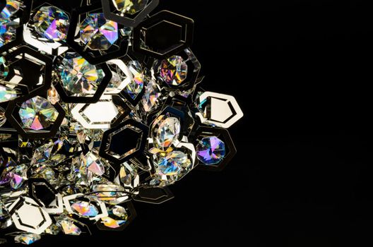 Contemporary glass chandelier fragment isolated over black background