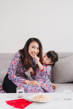 Vietnamese mother and daughter celebrate new year at home. Tet Holiday.