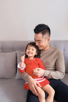 Happy asian family having fun at home.