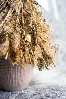 Christmas interior decoration with xmas tree made with dry grass, branches and leaves