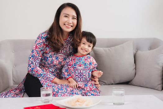 Vietnamese mother and daughter celebrate new year at home. Tet Holiday.