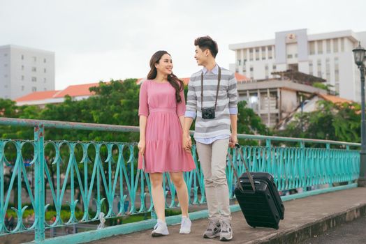 Young lovers walking around city on vacation, enjoying traveling together, outdoors.