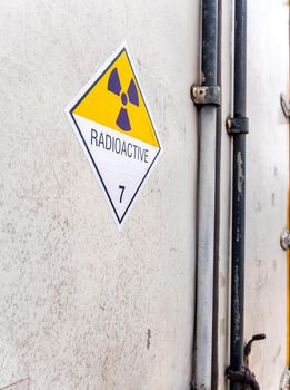 Radiation warning sign on the Hazardous materials transport label Class 7 at the aluminum container of transport truck