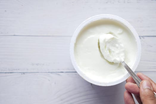 fresh yogurt in a bowl on table .