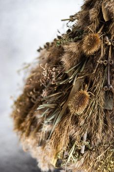 Christmas interior decoration with xmas tree made with dry grass, branches and leaves