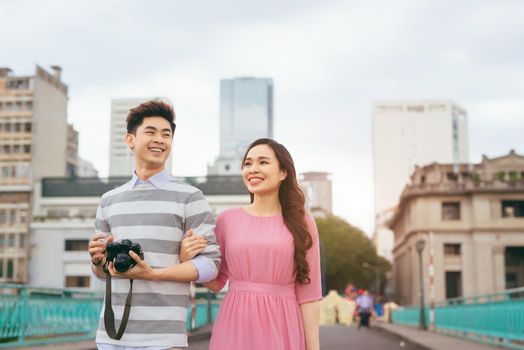 Young lovers walking around city on vacation, enjoying traveling together, outdoors.