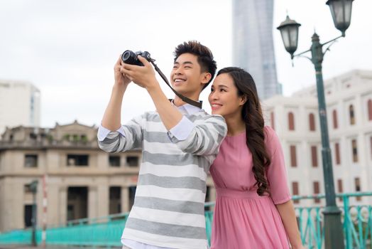 Photographers taking pictures of buildings in Saigon