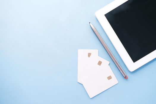 credit cards and digital tablet on blue background ,