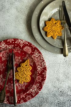 Festive table setting decorated with gingerbread cookie for Christmas dinner
