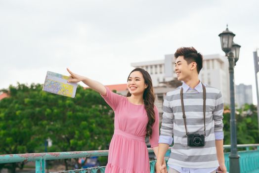 Young lovers walking around city on vacation, enjoying traveling together, outdoors.