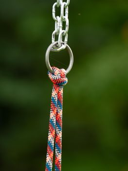 Connection of a steel chain and a solid hemp rope on a children's climbing frame.