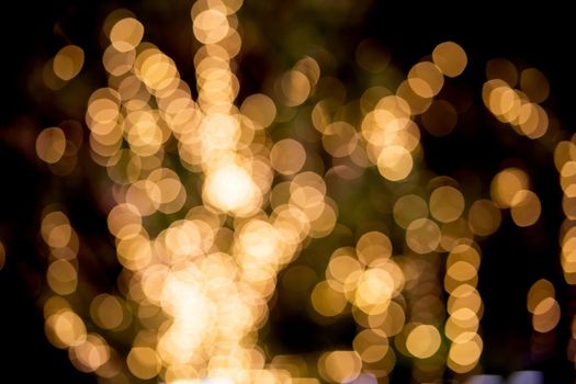 Gold or yellow bokeh texture background with glowing and illuminated, holiday and festive for celebration, New Year or Merry Christmas, no people, blur and defocused with graphic or effect.