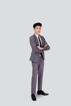 Full length portrait businessman in suit with crossed his arms standing isolated on white background, young asian business man is manager or executive having confident is positive with success.