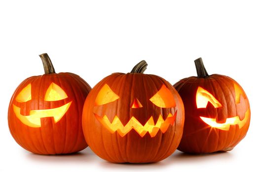 Three glowing Halloween Pumpkin lanterns isolated on white background