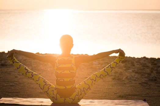 Yoga practice. Woman doing asana at sunrise