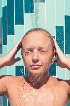 Sensuous slim woman taking shower at the beach