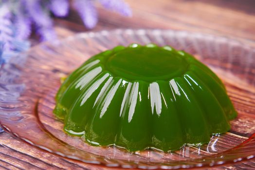 close up of red jelly on plate on table