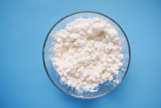 close up of cottage cheese on spoon on table