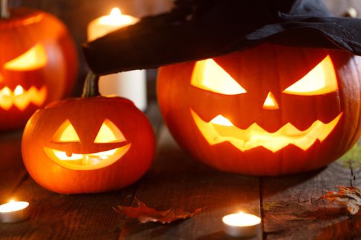 Jack O Lantern Halloween pumpkin with witches hat and burning candles