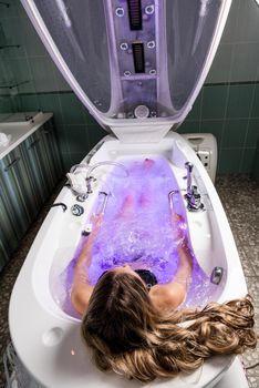 Beautiful woman relaxing in jakuzzi bath