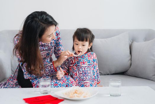 Vietnamese mother and daughter celebrate new year at home. Tet Holiday.