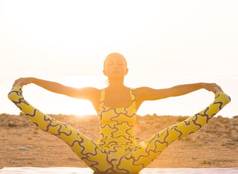 Yoga practice. Woman doing asana at sunrise