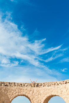 Woman doing yoga asana at exotic ancient location