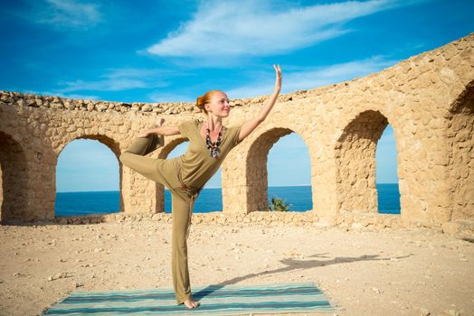 Woman doing yoga asana at exotic ancient location