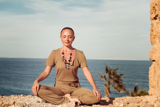 Woman doing yoga asana at exotic ancient location