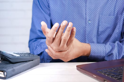 man suffering pain in hand close up .