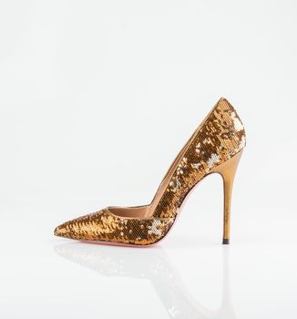 Golden fashionable women shoe shot in studio