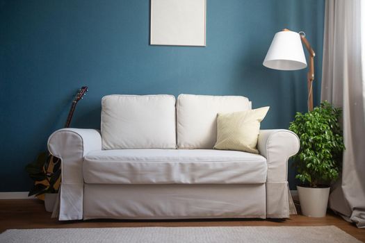 Classical scandinavian design with blue walls and night grey sofa