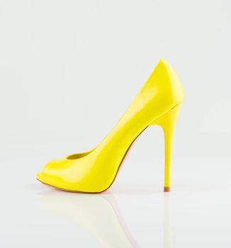 Modern fashionable yellow women shoe shot in studio