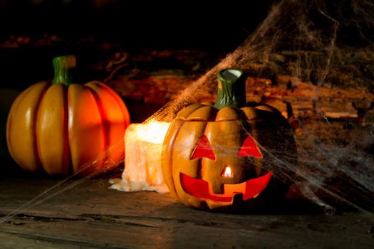 decoration for the hallowen celebration with pumpkins, spiders, candles on rustic wood