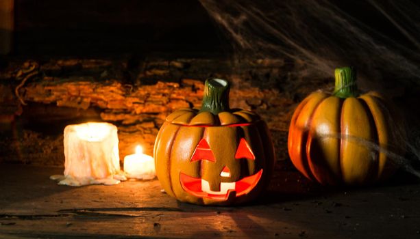 decoration for the hallowen celebration with pumpkins, spiders, candles on rustic wood